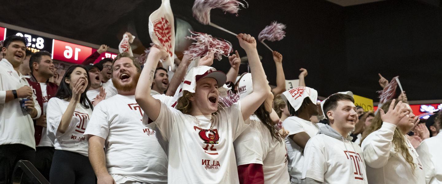 students cheering at a Temple basketball game.